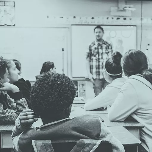 A classroom with children and a teacher