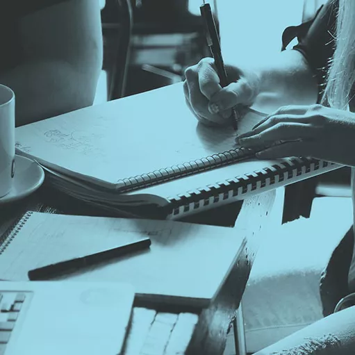 team member making notes at a meeting