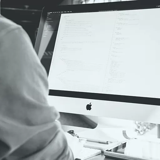 Drupal developer working on an iMac