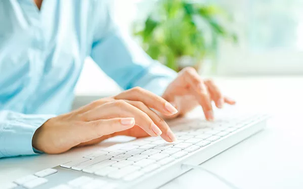 Lady typing on a keyboard